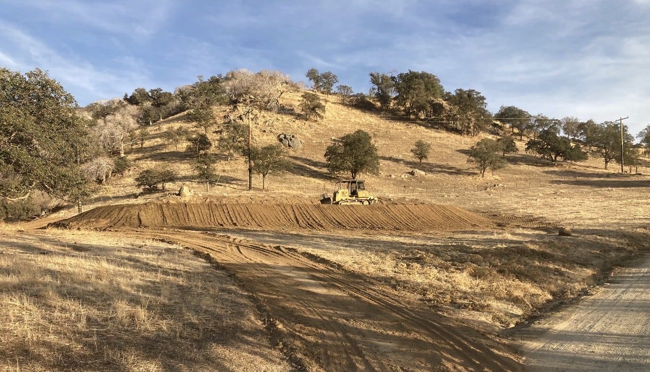 Bulldozer grading a hillside in the Central Valley foothills