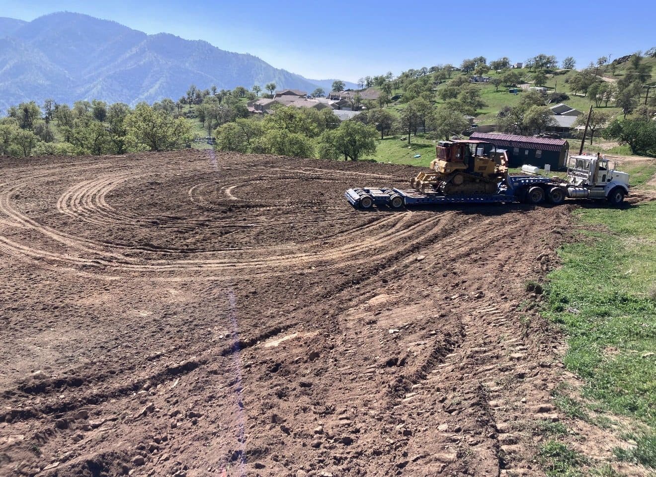 Lowbed truck hauling a bulldozer to a job site